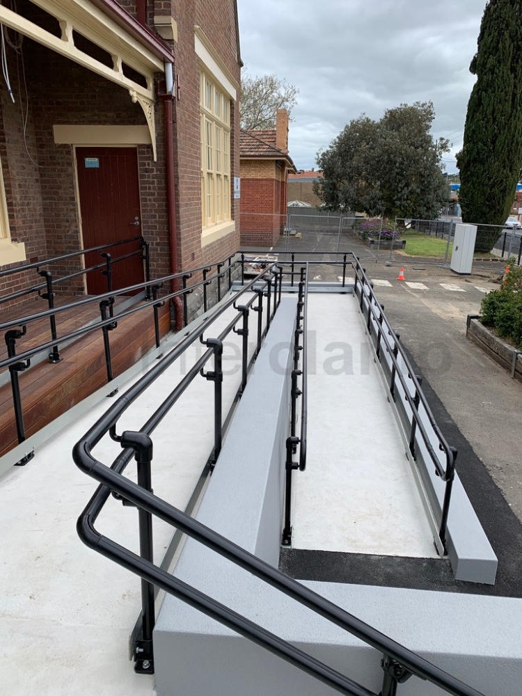 Double rail offset handrail system installed on a school access ramp